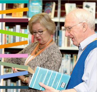 A photograph of library staff choosing books from the shelves at the library